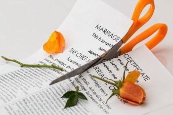 Marriage Certificate and a Rose Being Cut by a Pair of Scissors | Divorce & Immigration Blog